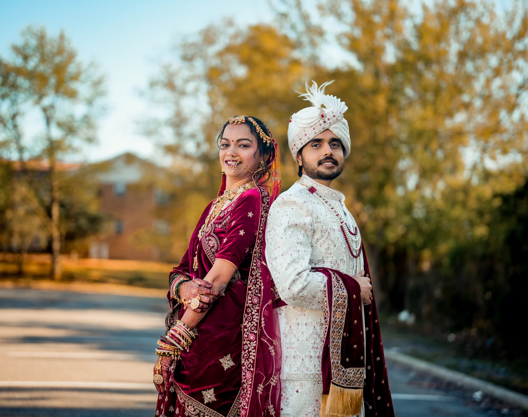 Indian bride and groom standing together in rich traditional wedding attire
