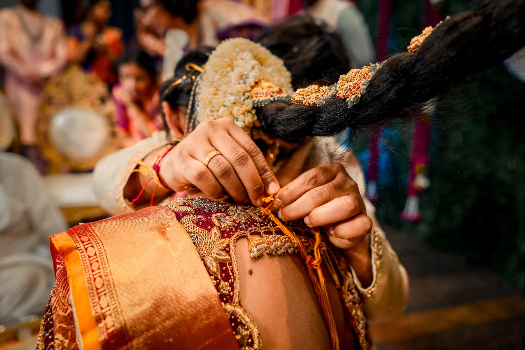 A groom ties the sacred mangalsutra around his bride during an Indian wedding ceremony